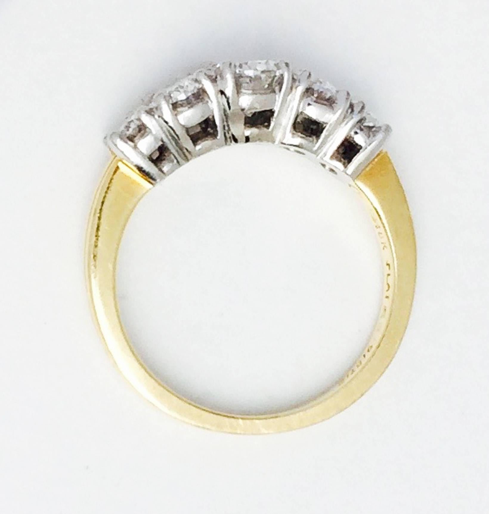A fine and rare Cartier Paris five-stone diamond ring. Signed sculpted yellow gold band features a platinum setting and five sparkling oval cut E VVS diamonds, approx. 3.5ctw. Size 4.75. Excellent with no issues.