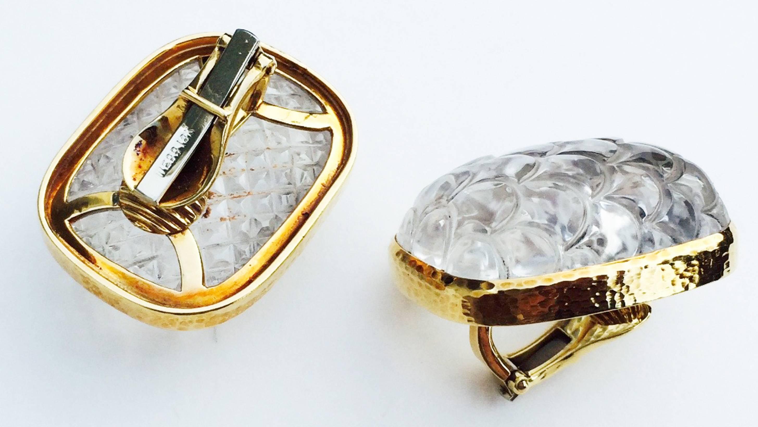 A fine pair David Webb rock crystal ear clips. Large signed hammered yellow gold items feature bezel mounted carved rock crystal centers. Original clip backs intact. Excellent with no issues.