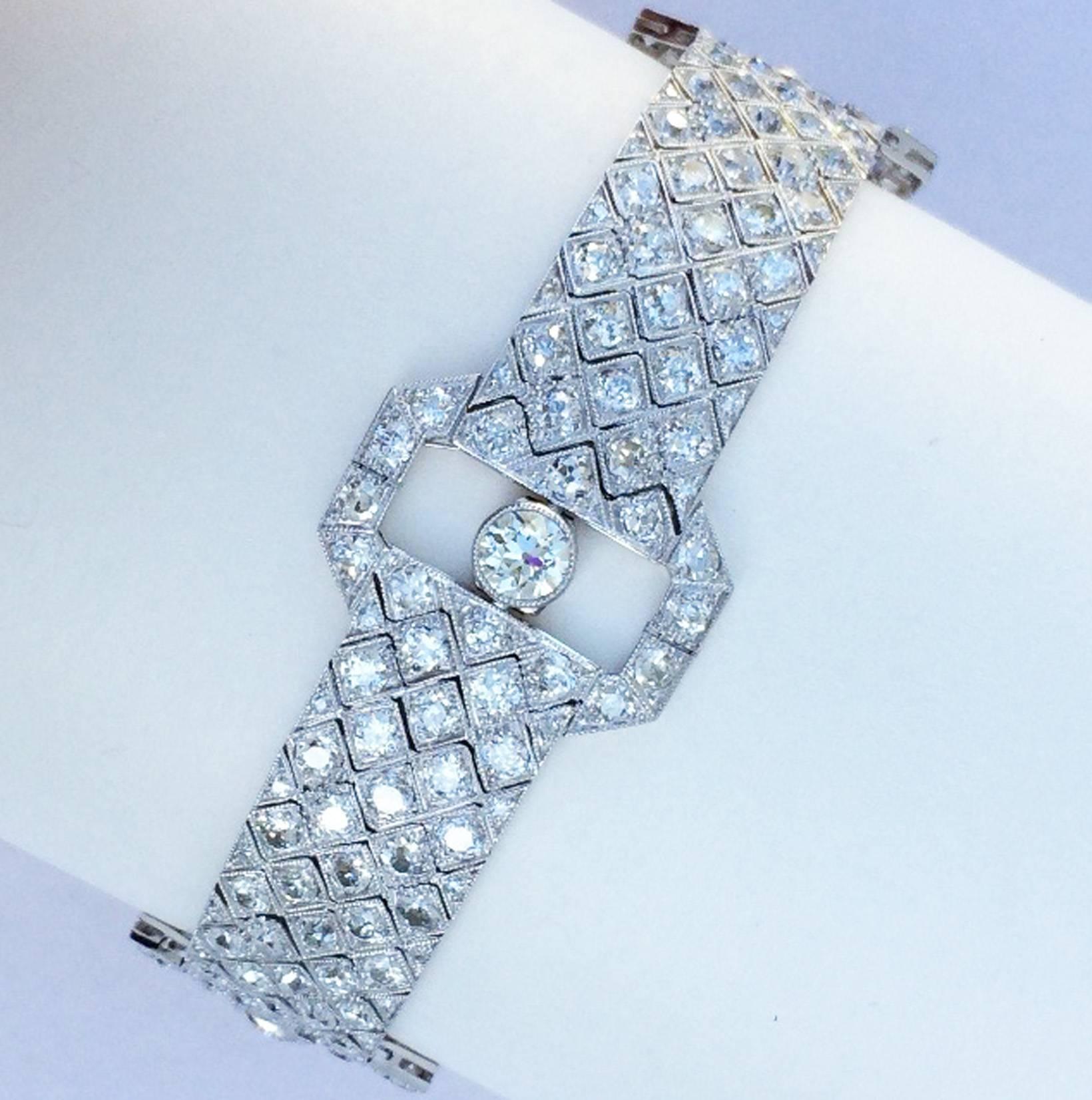 A exquisite art deco diamond and platinum bracelet. Hallmarked item for Benjamin Harry Britton & Sons (Birmingham), circa 1925. Precision linked item features old European and European cut diamonds (SI 2), approx. 20ctw including four .5ct centers.