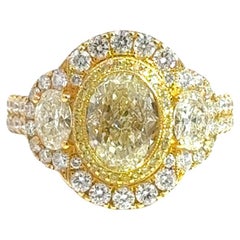 18K Yellow Gold Three-Stone Oval Diamond Ring with Fancy Yellow Accents