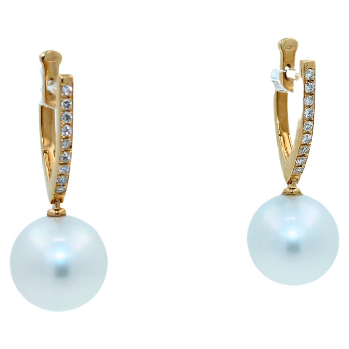 White AAA Quality South Sea Pearls
Striking Silvery Hue with Light Blue Iridescent  Tones
Very Reflective Surface - Almost Mirror-Like 
Full Classic Sphere Shapes
14MM Round Diameter Size
12.5 Grams Total Weight
3.5 cm Full Length
0.50 cts Diamonds