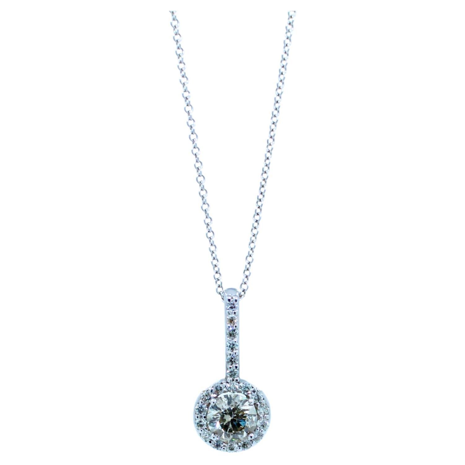 14 Karat White Gold
0.30 cts center Diamond I Color with warm, silvery tone 
0.10 cts Halo pave Diamonds
18 inches dainty cable chain