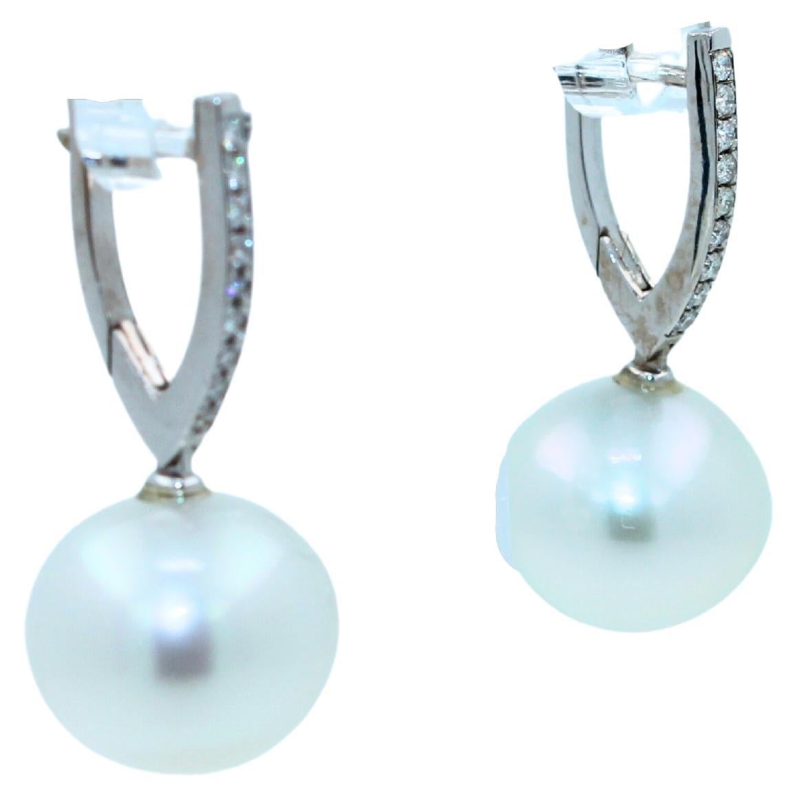 White AAA Quality South Sea Pearls
Length 15MM Width 16MM (Estimate for both)
Striking Silvery Hue with Light Blue Iridescent  Tones
Very Reflective Surface - Almost Mirror-Like 
Special Rare Shapes - Wide Ellipse - Horizontal Sphere Form
0.50 cts
