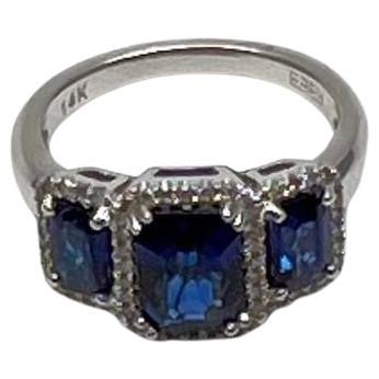 A study in elegance, depth, and brilliance.
This striking ring showcases three captivating blue sapphires, each set in a refined arrangement. The central stone is flanked by two equally stunning companions, all encased in a sleek, polished band. The