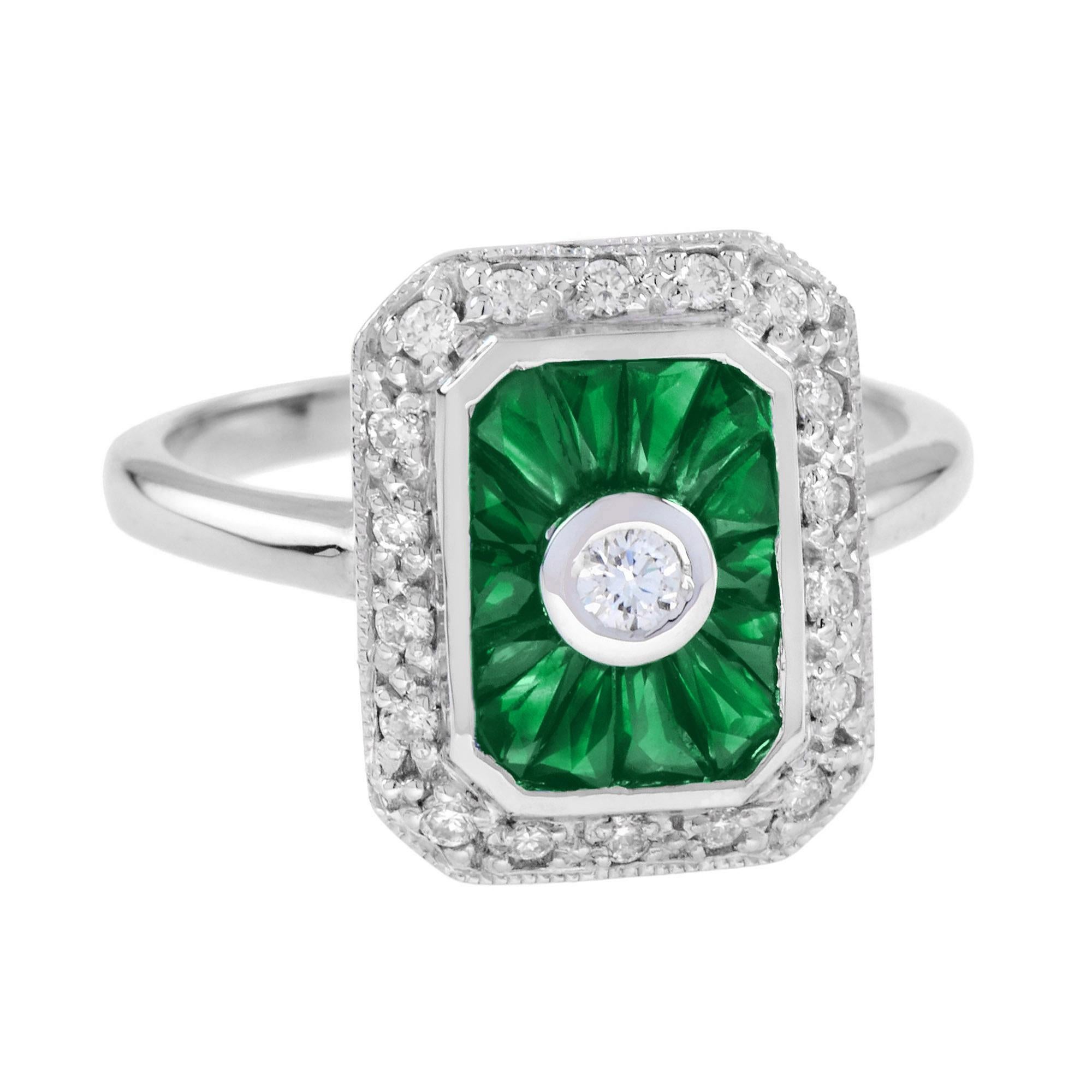 Un anello con diamanti e smeraldi di ispirazione Art Déco assolutamente mozzafiato, con smeraldi taglio francese che circondano un diamante rotondo centrale come una vasca d'acqua in una fontana. Lo scintillio continua fino ai bordi con diamanti