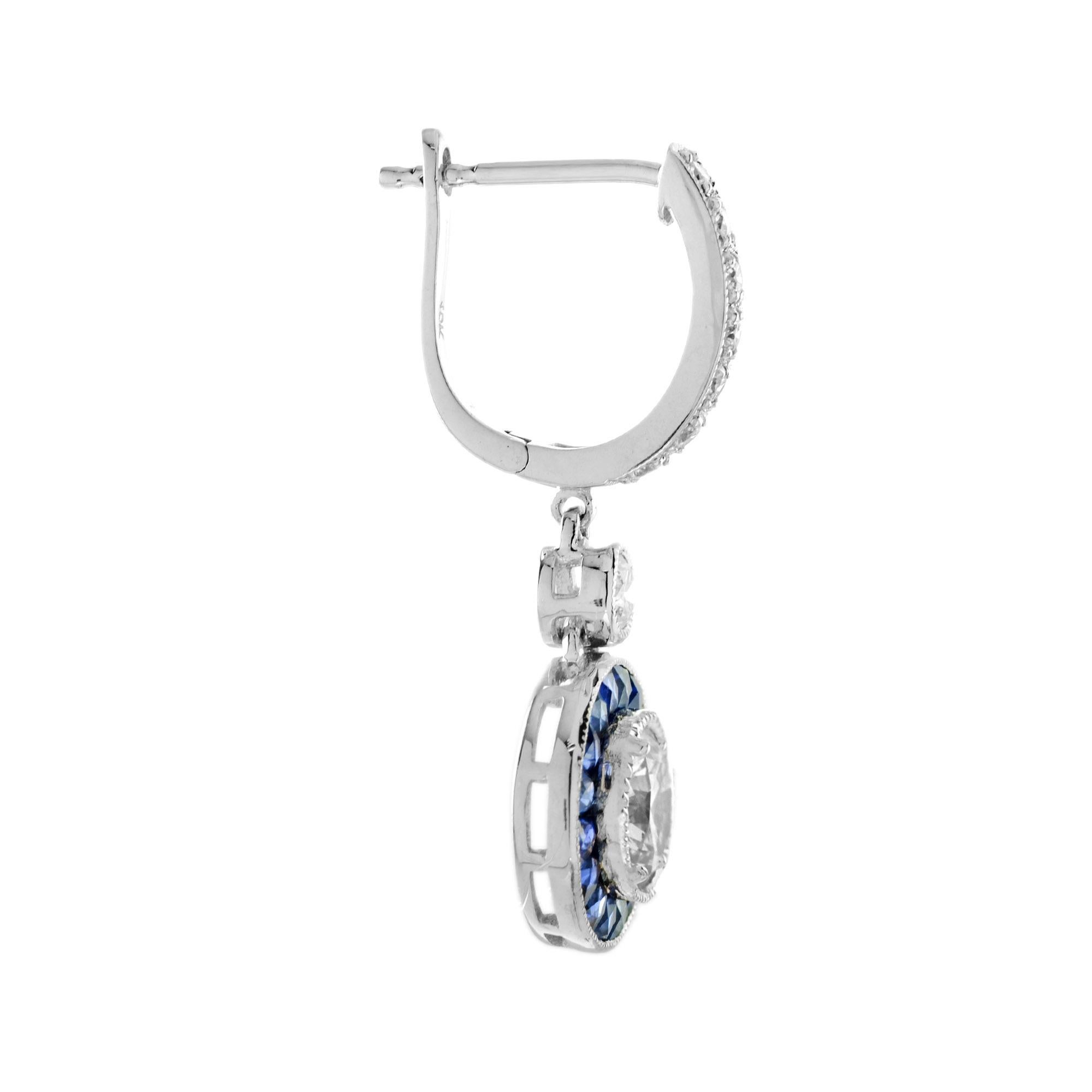 Exquisite early Art Deco inspired Diamond and Blue Sapphire earrings. The central Diamond is surrounded by finely set double halo sapphires to an outer creating a chic octagonal form. The earrings are perfectly worn with the same design halo ring.