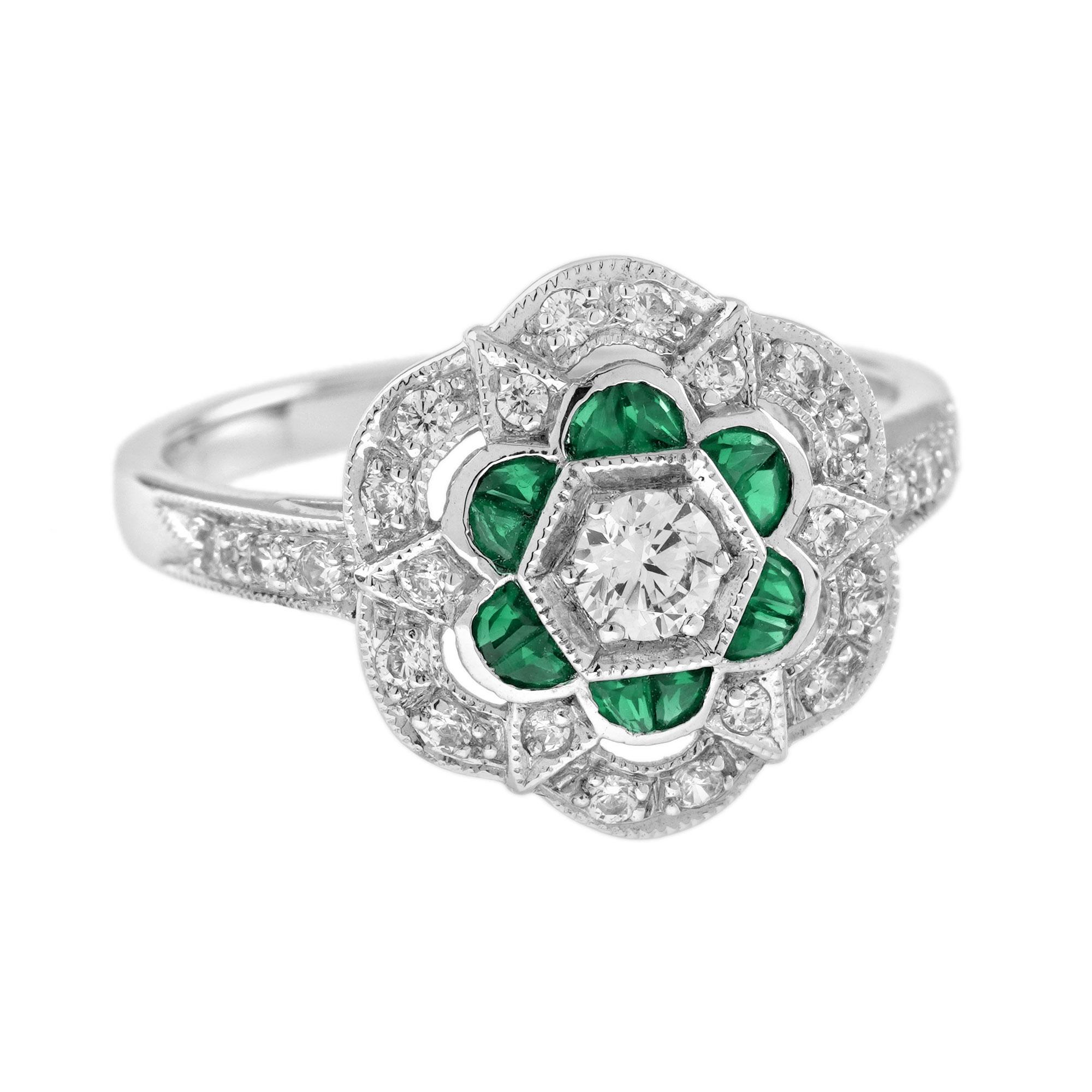 Questo divertente anello in stile Art Déco a forma di fiore è impreziosito da un diamante rotondo bianco e scintillante di ..carati, incastonato in un delizioso contorno traforato e scintillante di smeraldi e diamanti tagliati alla francese. Le