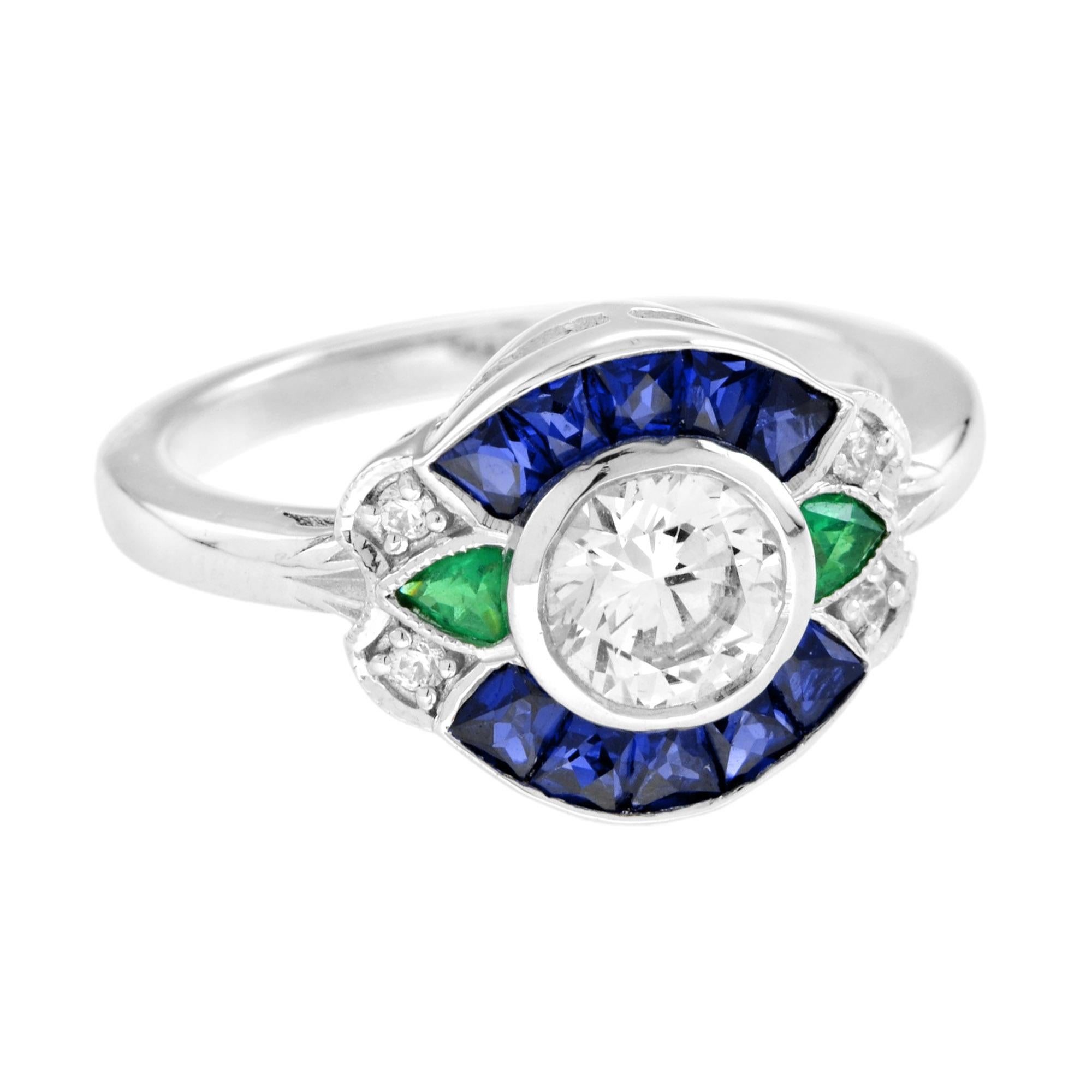 Questa creazione è squisita. Il cuore di questo anello è costituito da uno splendido diamante con incastonatura a castone, incorniciato da una delicatissima texture milgrain. Il diamante centrale è impreziosito da zaffiri e smeraldi taglio francese.