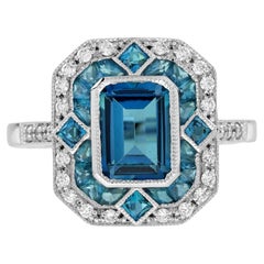 Anillo de oro blanco estilo art déco inspirado en la época del topacio azul londinense y halo de diamantes