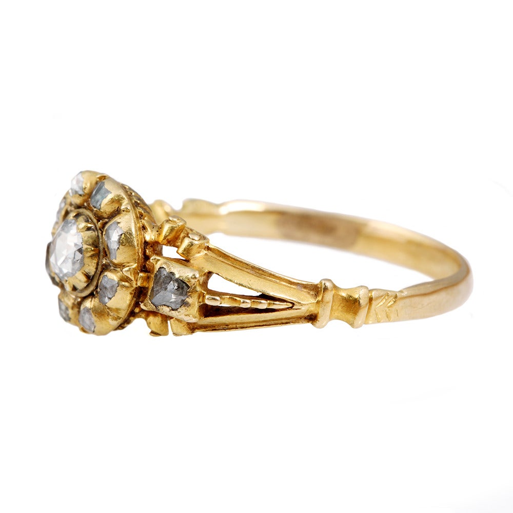 Early 18th century rose cut diamond cluster ring in 18k gold. Spanish or Portuguese in origin with a reeded back detail. Circa 1720. Beautifully preserved. 

Size 8, can be sized.