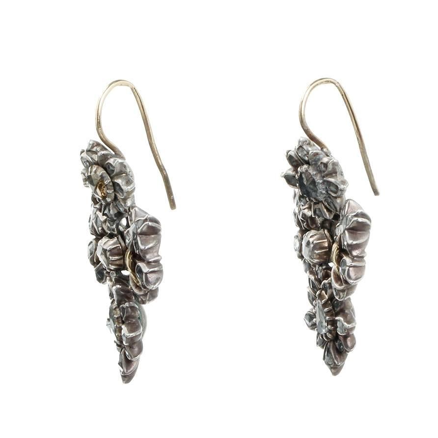 Beautiful 18th century diamond earrings in a classic lazo motif. In the Iberian peninsula this style persisted into the early 19th century. Portuguese in origin, Circa 1760. 

Rose cut diamonds in silver with gold detail. 18k French hook earring