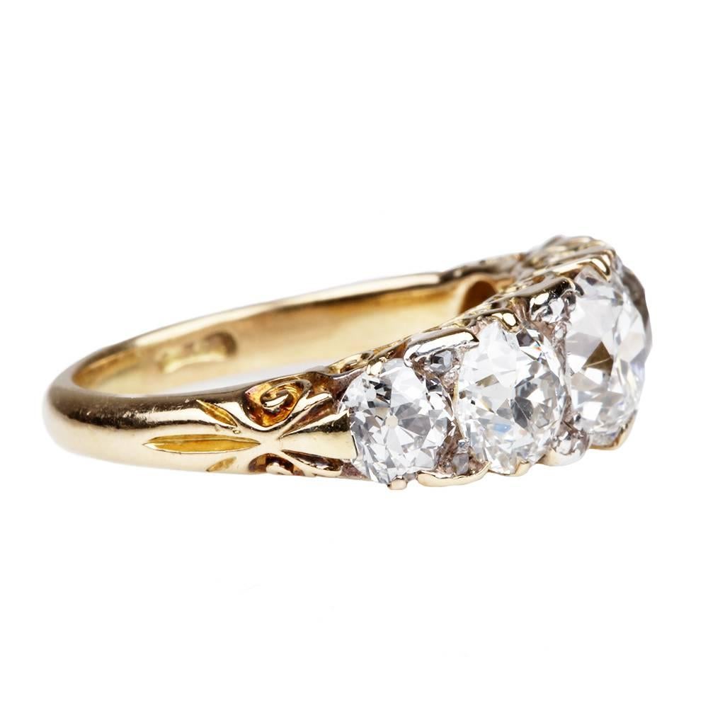 Late Victorian five stone diamond ring, 18k gold. Old mine cut stones weigh approximately 4 in total carat weight. English in origin. Circa 1880.

Size 6.50 , can be resized. 