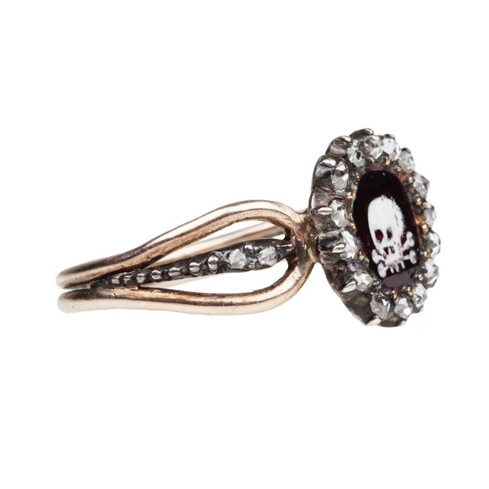 

18th Century memento mori enamel skull garnet and diamond ring. Table cut garnet and rose cut diamonds set in silver on gold settings, with forked shoulder details. Circa 1730.

This ring is literally a textbook example in excellent condition.