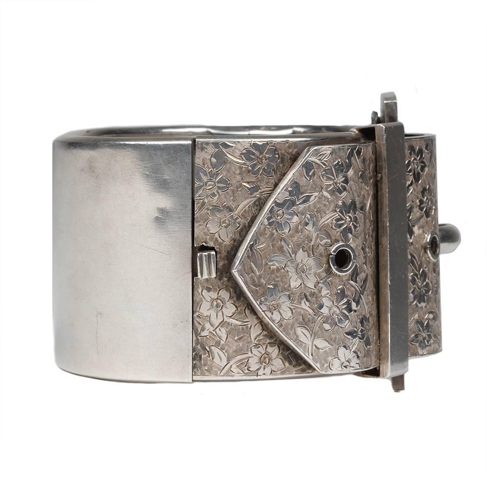 Victorian Sterling Buckle Bracelet. Detailed floral engraving and interior engraving "From Arthur, 17 April 1880". English in origin.

Hinged at side with push button closure. Inner circumference measures approximately 7". Bracelet is