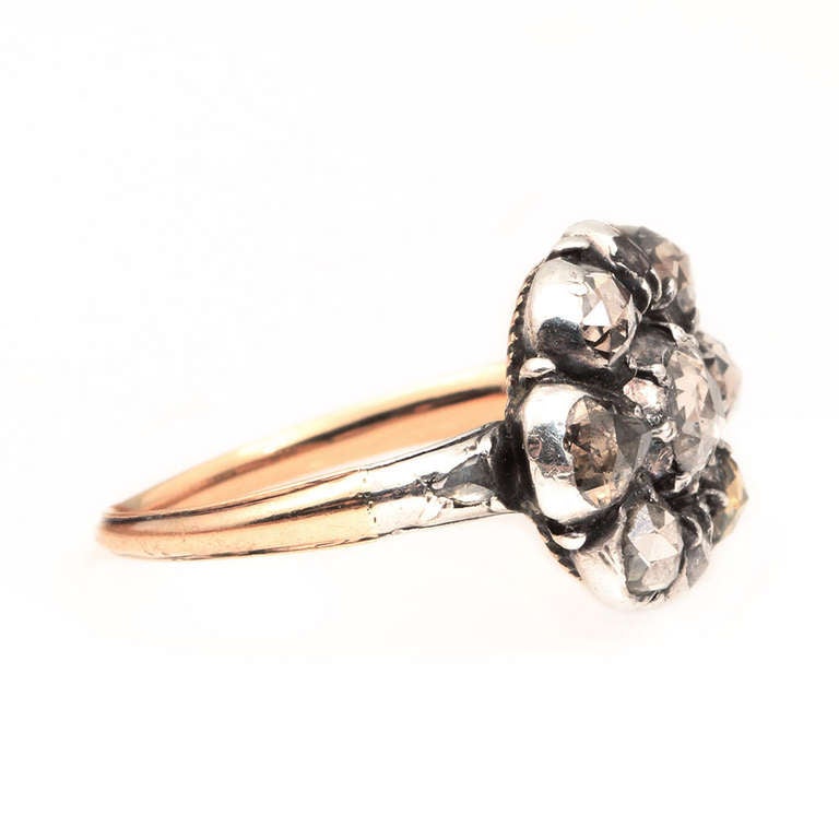 Beautiful early rose cut diamond ring in 18k gold and sterling silver. Circa 1700-1780. Diamonds set in silver, back and shank in gold. Reeded detail on back of setting. Size 6.5 can be sized. Shown on model with two of our antique gold bands