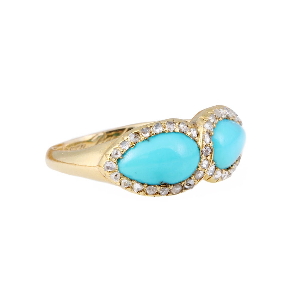 Victorian Persian turquoise & diamond ring in 15k gold. Rose cut diamonds surround twin pear shaped turquoise stones in an infinity motif. English in origin, Circa 1856.

Size 7.5 , can be sized.