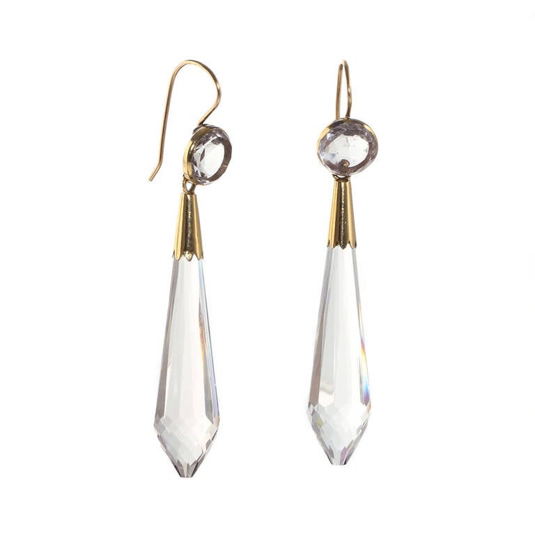 Victorian era rock crystal earrings. The torpedo drops are carved from crystal clear quartz stones. In 18k yellow gold. English in origin, Circa 1870.