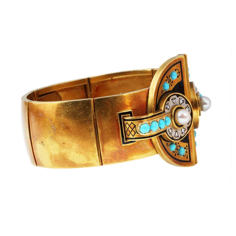Victorian era 18k gold bangle. Black and white enamel detail with Persian turquoises and natural pearls. The bracelet is masterfully hinged at 4 separate points with a push button closure. Circa 1870, French Markers Marks.

Inner circumference