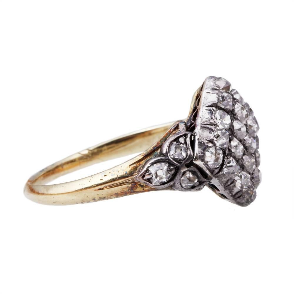Early Victorian diamond ring. 20 Old mine cut diamonds in a diamond cluster design with 6 old mine cut diamonds on the shank. Approximately 1 carat in total diamond weight. The diamonds are set in a silver open back setting on an 18k gold shank.