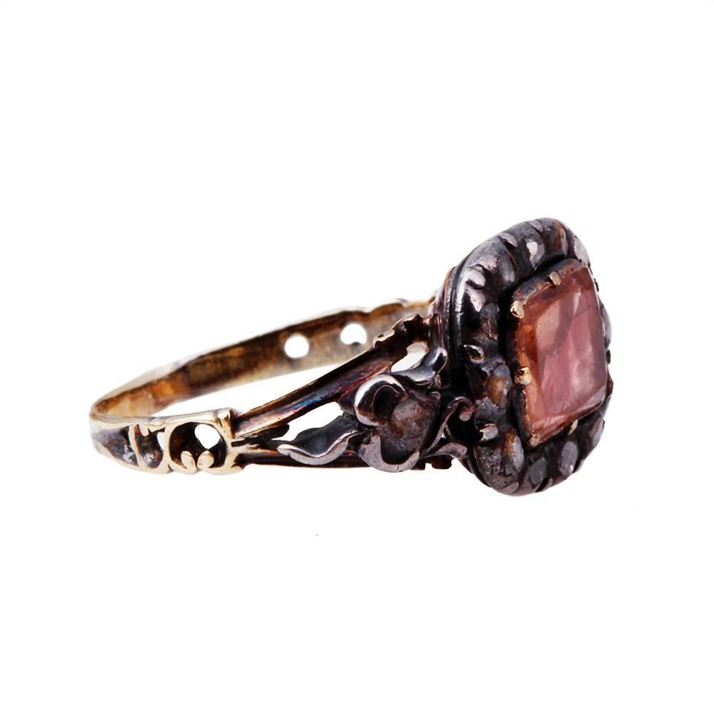 18th-century Portuguese natural pink topaz and diamond ring. Silver on settings on gold. Reeded back. The topaz is set in high carat gold with 14 rose diamonds set in silver. Beautifully original details, including the reeded back.  The ring has