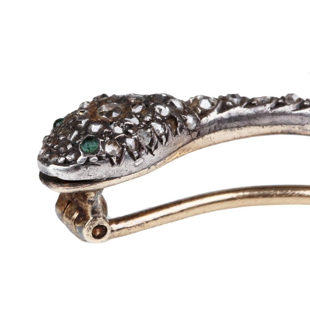 Georgian rose cut diamond snake brooch with emerald stones for eyes. Diamonds are set in silver on gold. English in origin, Circa 1820. 

3