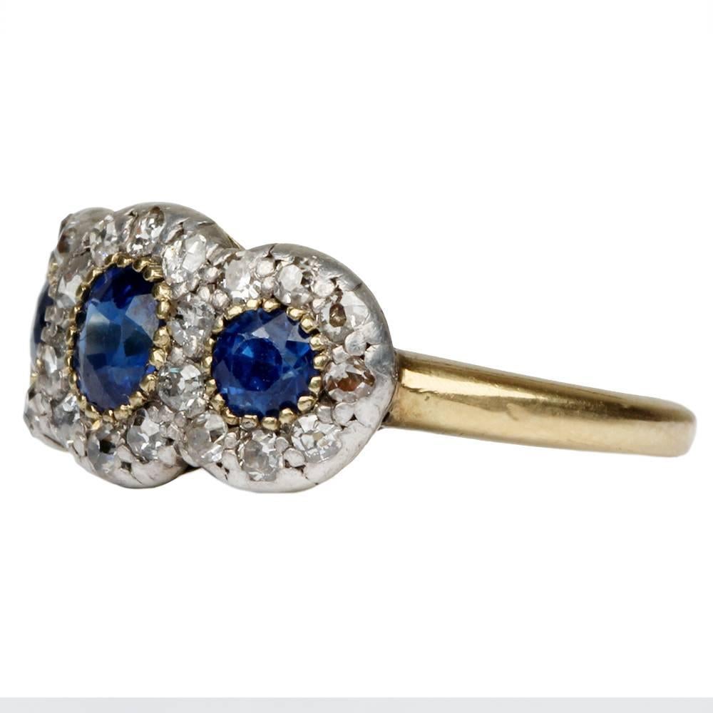19th Century triple sapphire and diamond cluster ring. Sapphires are set in gold setting and diamonds are set in silver on gold band. English in origin. Circa 1880.

size 6 , can be resized.
