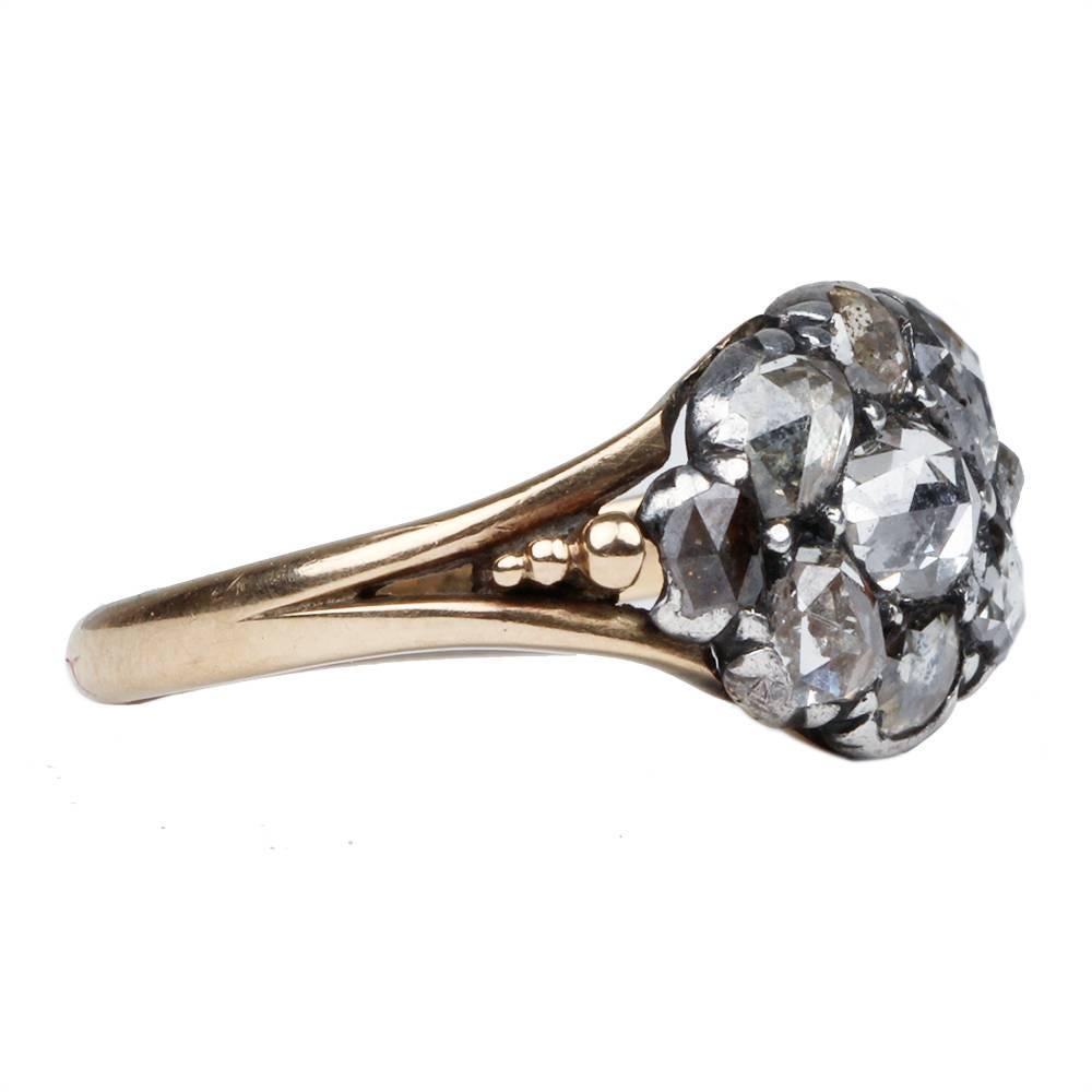 Georgian rose cut diamond cluster ring.  Nine rose cut diamonds are set in silver on an 18k gold shank, which is appropriate for the time period. The rose cut diamond cluster ring dates to the last 20 years of the 1700's. English in origin. Circa