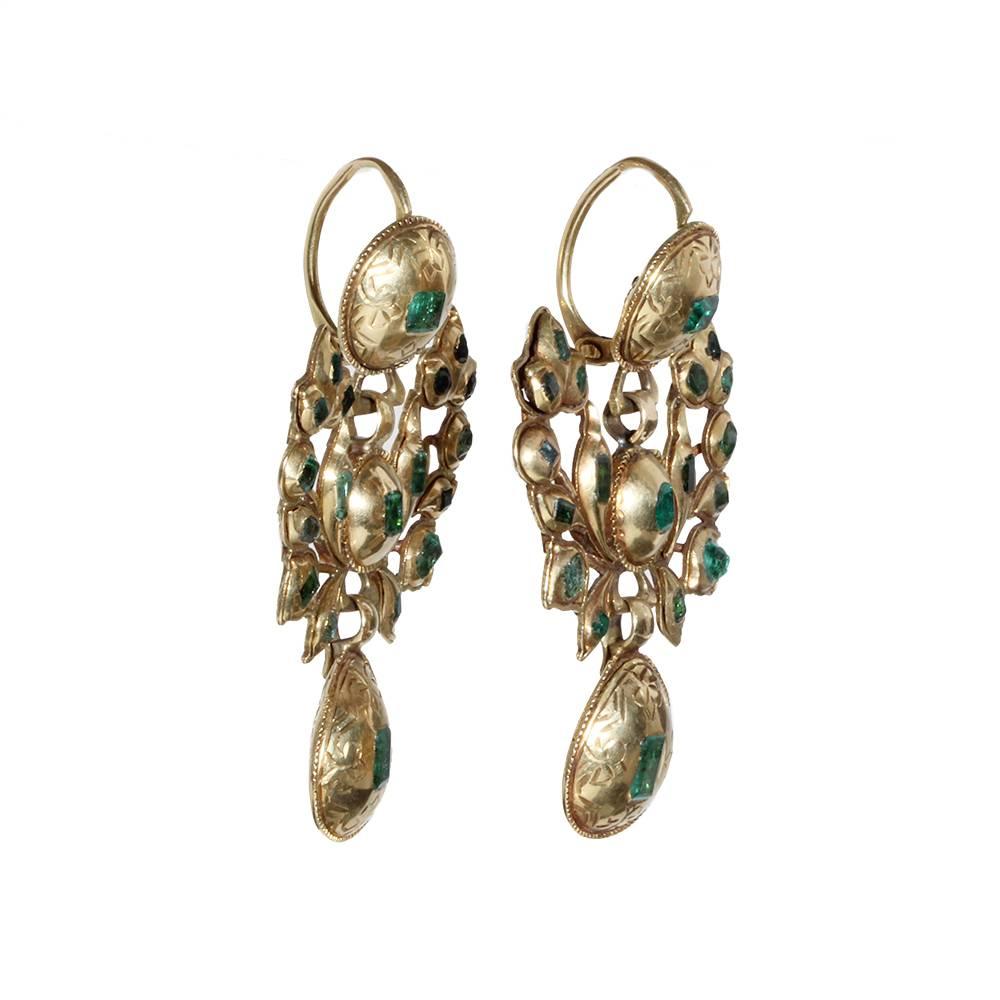 18th century Iberian gold and emerald earrings. Hand made in 18k gold and emeralds, sourced in colonial mines in Columbia and Peru. Back to front ear hooks, typical for the period.  Spanish in Origin, Circa 1750.

Earrings measure 1.75