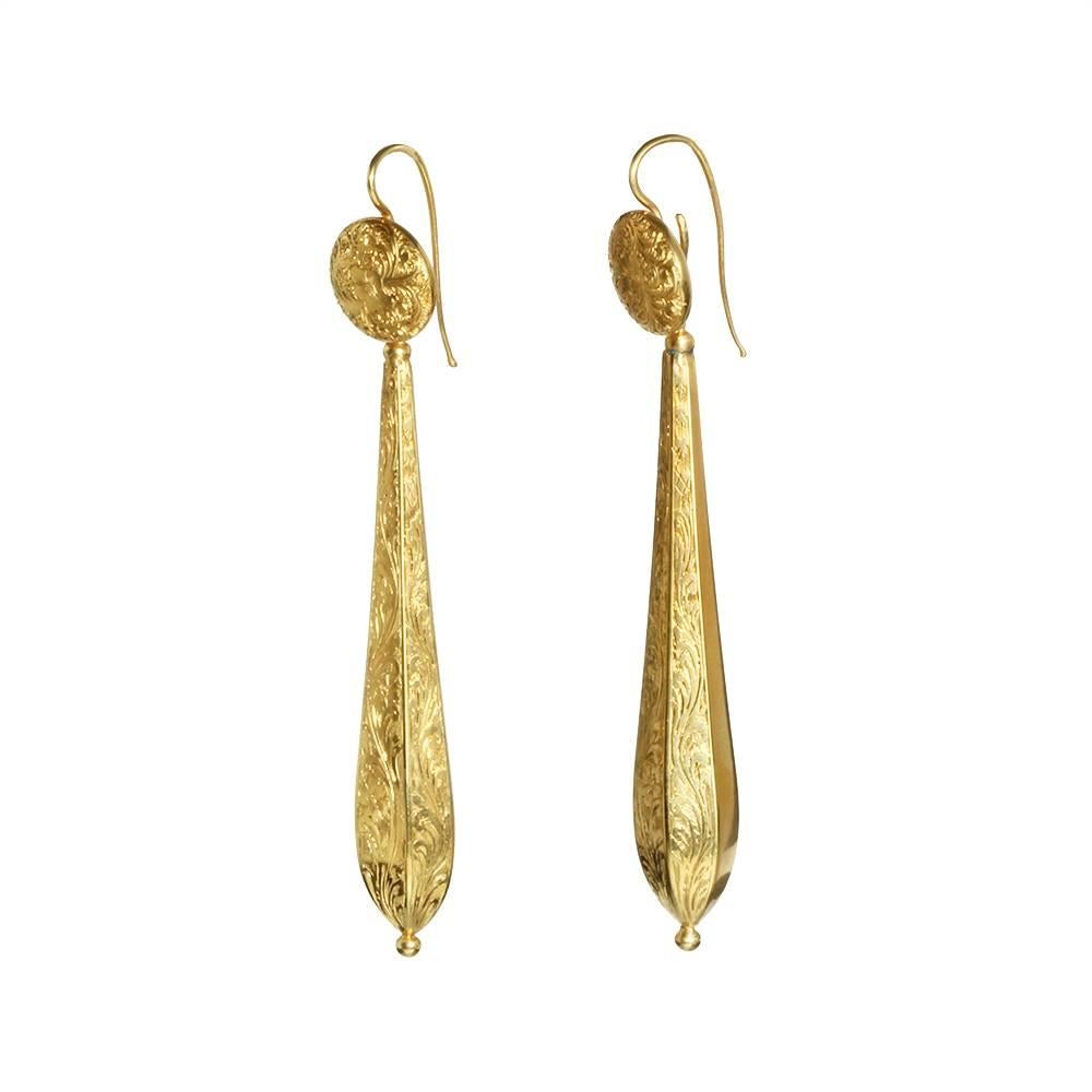Georgian Torpedo earrings in 15ct gold. Torpedoes can be removed and worn on the elaborately engraved side or the plain. Also the tops can be worn alone. Circa 1810, English in Origin.

Drop measures 2.75