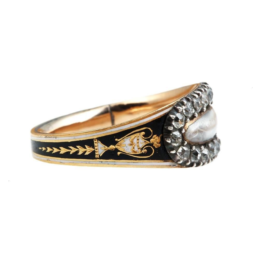 Georgian enamel and old mine cut diamond mourning ring with black and white urn detail on shank.  Braided hair behind the crystal. 