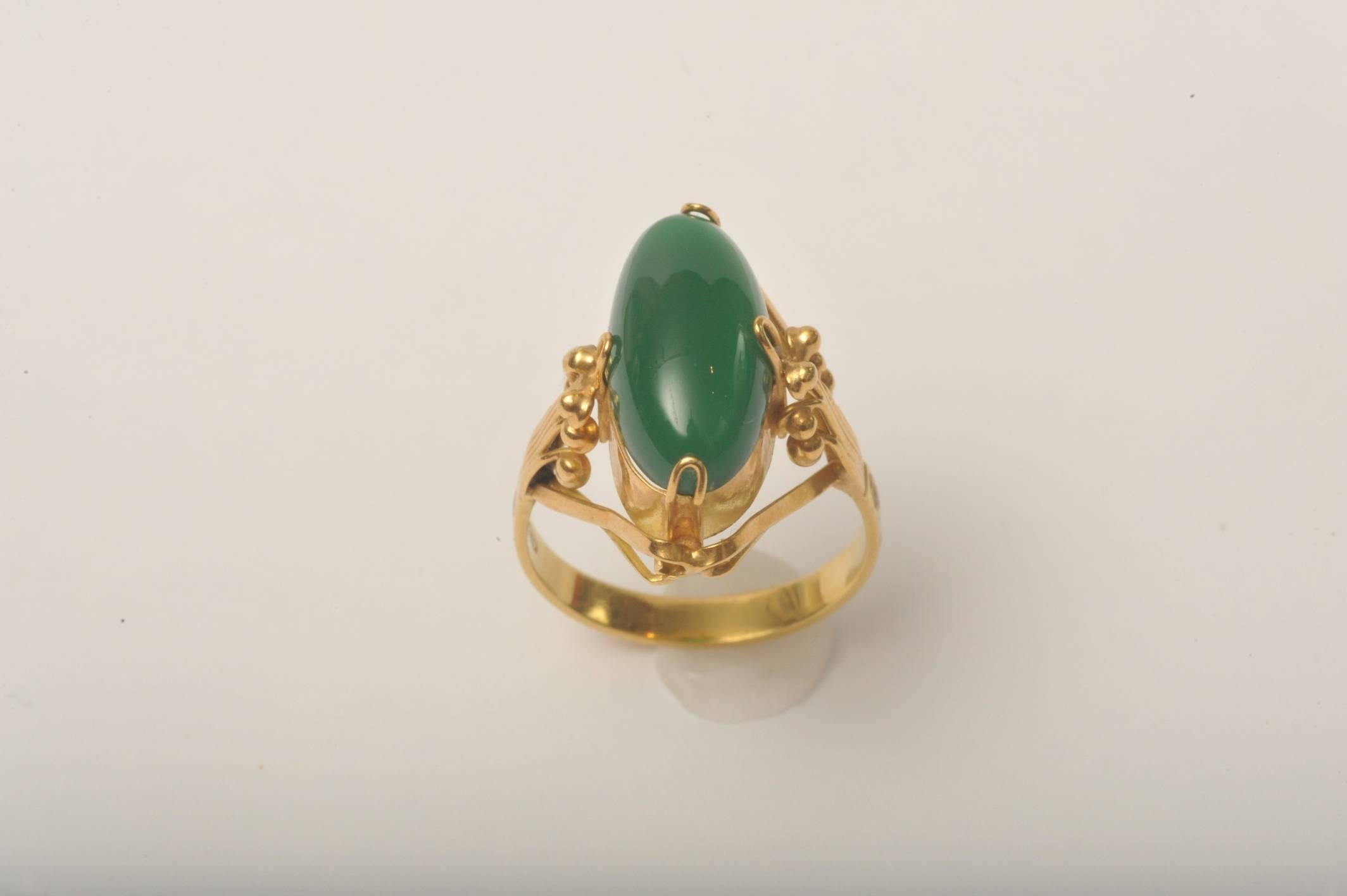 Stunning deco period ring of 18K gold and oval cabochon green chalcedony stone.  Fine workmanship and detailing.  Size is 9.25.  