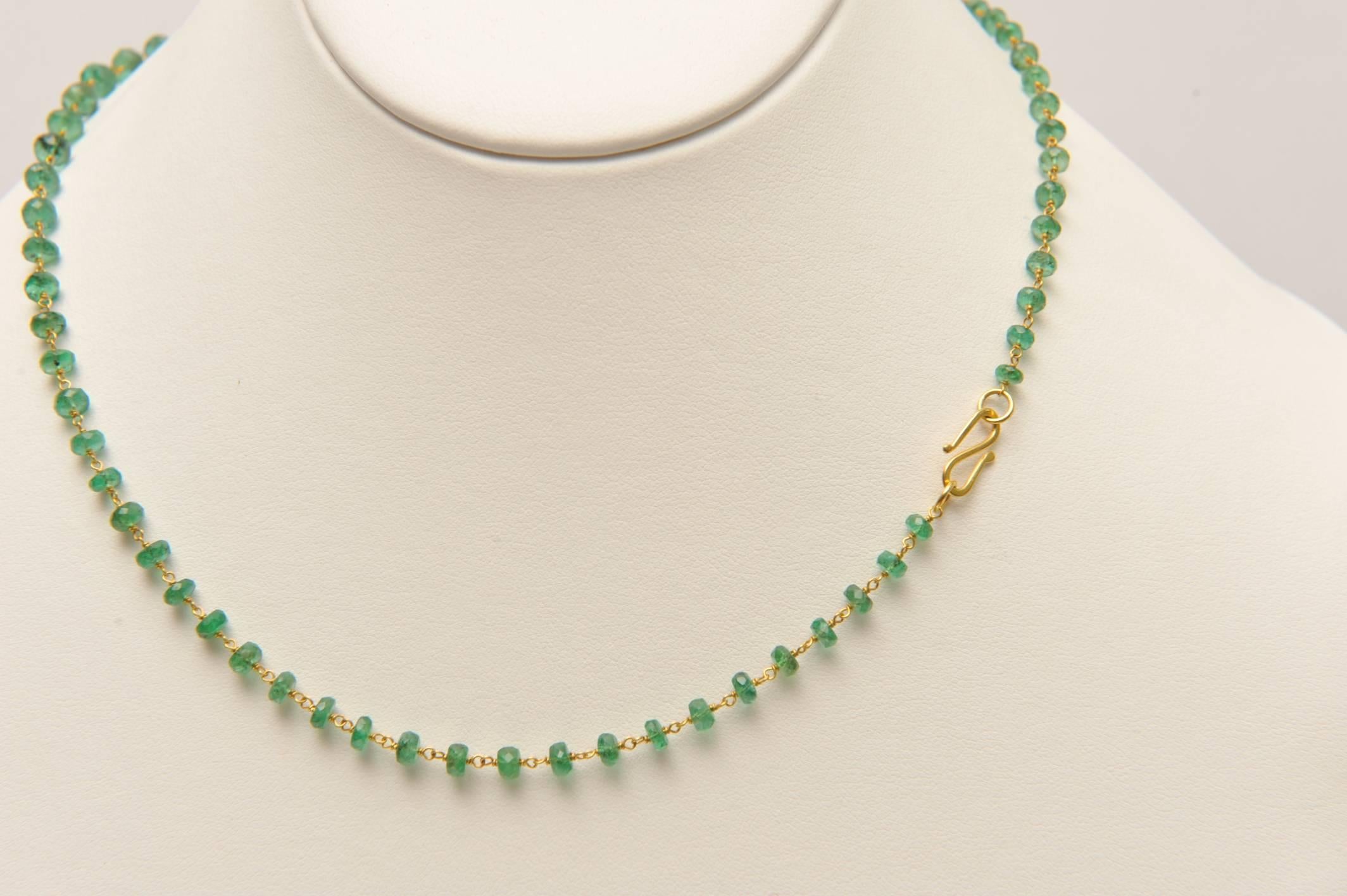 Faceted Colombian Emeralds with great color and life with 18K gold wire work between each bead and 18K gold S-hook clasp.  Beads are slightly graduated.