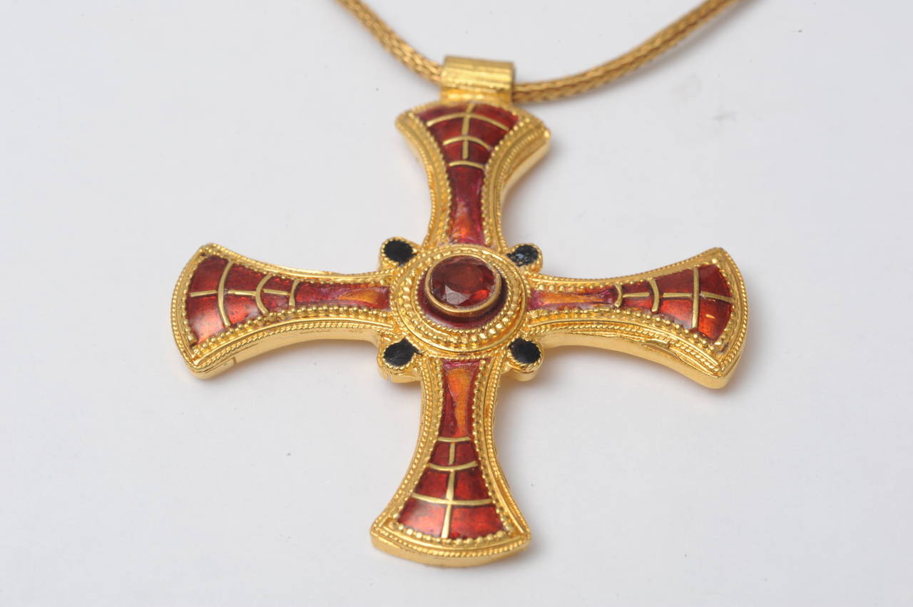 A beautifully made byzantine cross with fine granulation work with center faceted ruby and red enamel on a hand-woven 22K gold chain.  One end can be unscrewed so that you can take off the pendant.  I also have a shorter gold chain if you prefer--16
