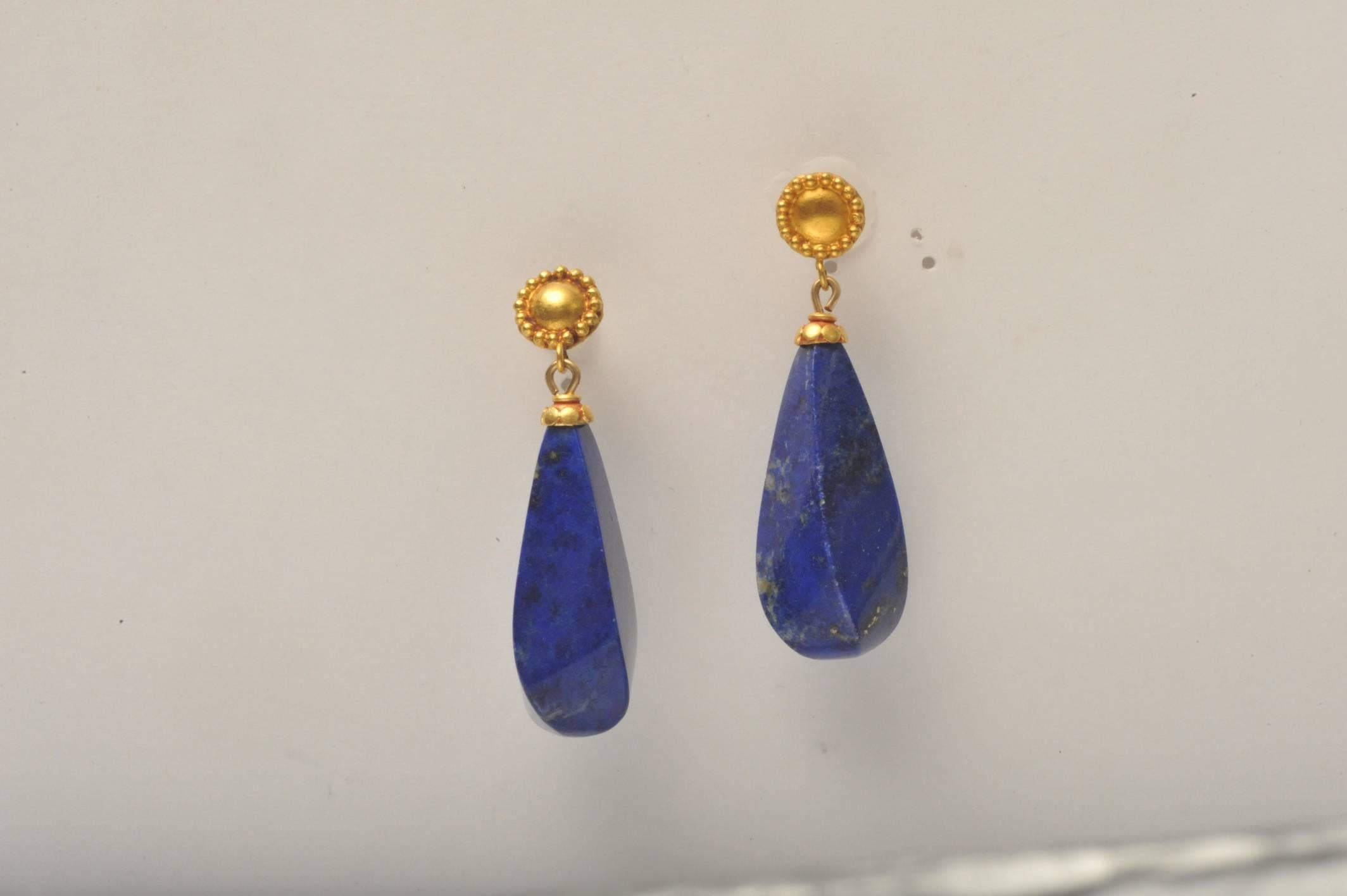 A brilliant pair of natural lapis lazuli cut in a rare and dimensional way, with 22K gold end caps mounted on 22K gold posts.

Fine Jewelry located on Nantucket island