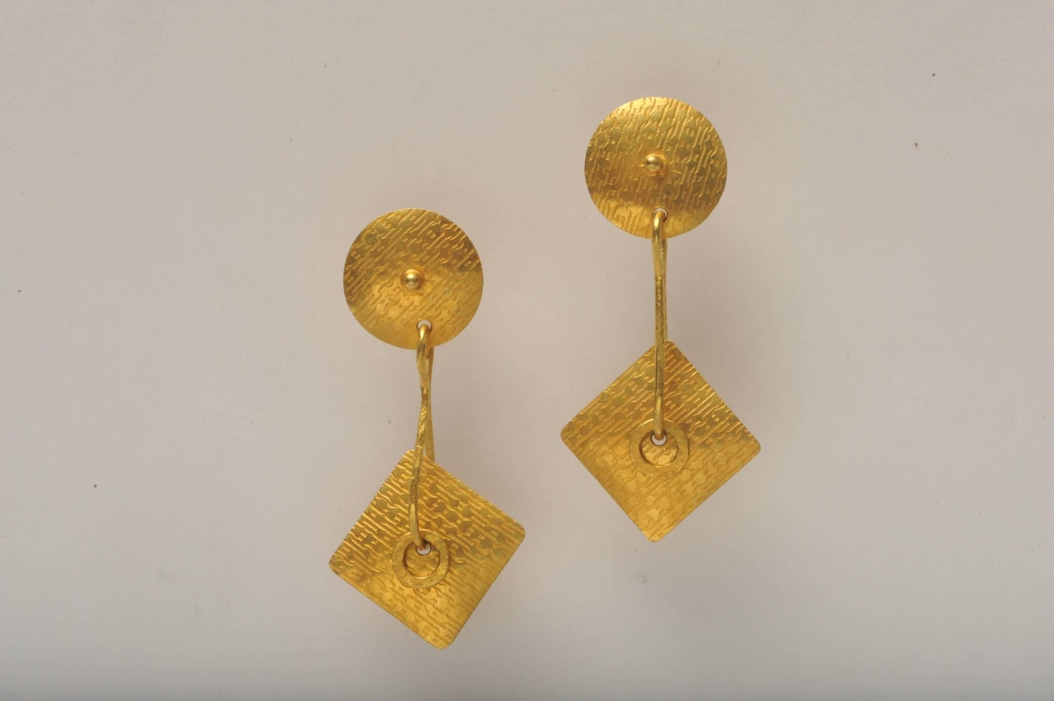 Unusual Art Deco, 22K gold earrings with fine hand-tooling design on the face of the earring.  Bottom portion is not fixed so offers movement through the loop.   Post back for pierced ears.