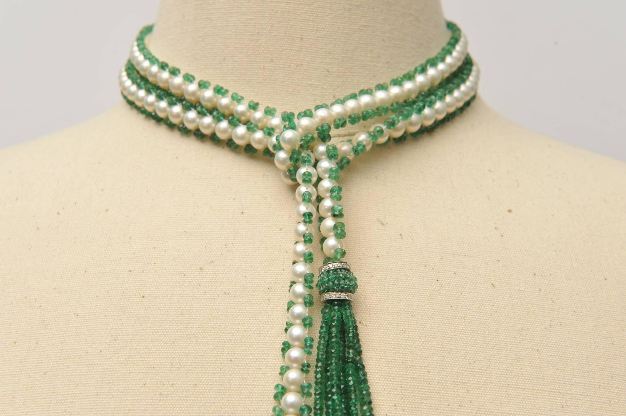 A stunning faceted emerald and cultured pearl lariat necklace with 18K white gold and diamond rondelles bordering the beaded emerald cluster above the tassel, and seed pearls at the bottom.  Wear this long or short, sexy either way.