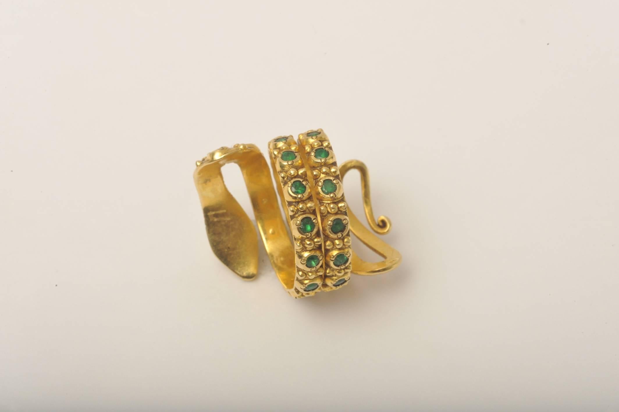 A fabulously made 18K gold coiled snake ring with beautiful hand tooling and granulation work with faceted emeralds, pave`-set sapphires and faceted pear-shape ruby third eye.  Ring size is 7 with a bit of flexibility.