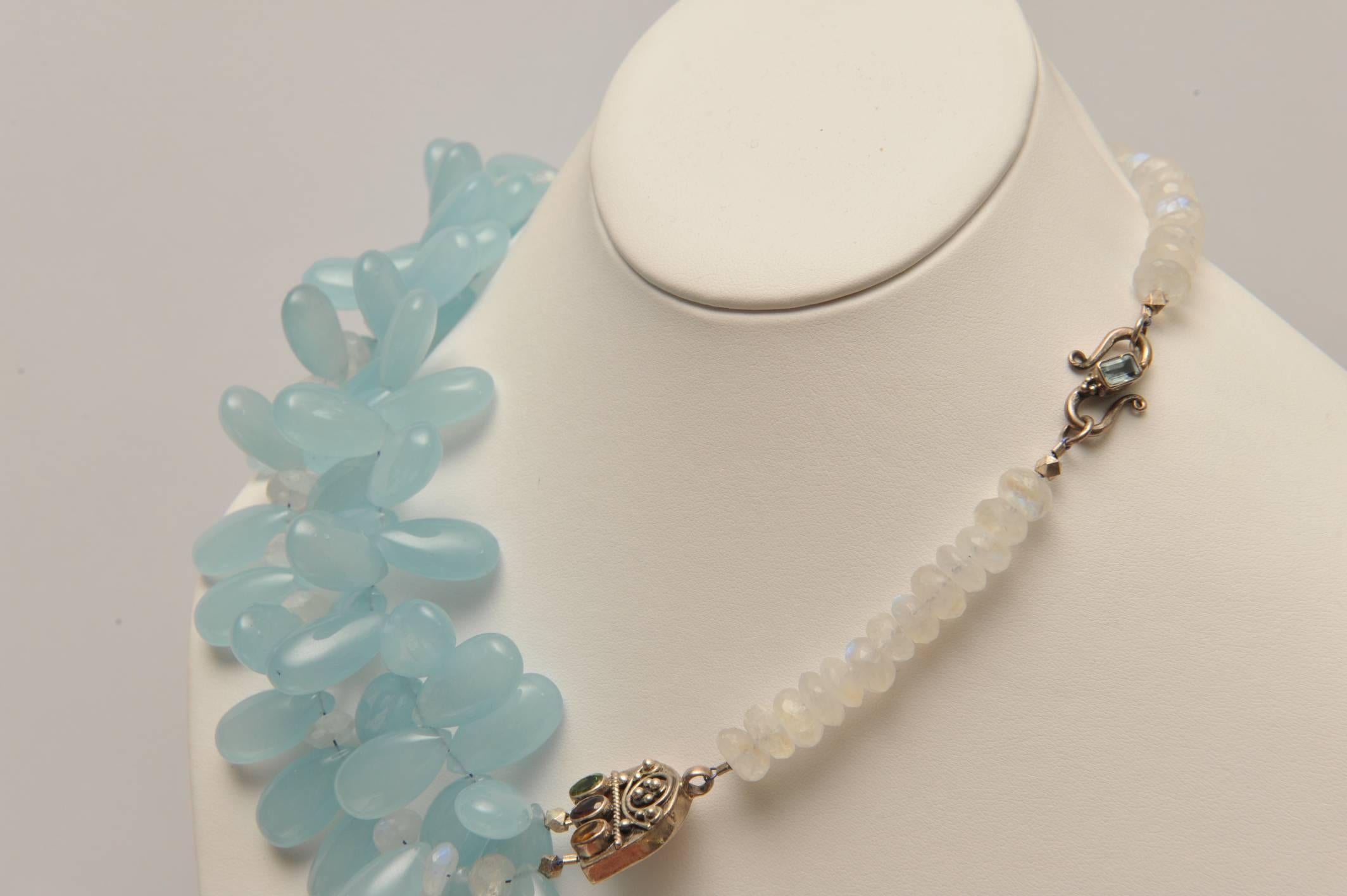 A beautiful 2-line cluster of pear-shaped chalcedony interspersed with faceted moonstones with an unusual sterling silver and semi-precious stone divider and faceted moonstones across the back.  A stunning combination of stones.  Designed by Deborah