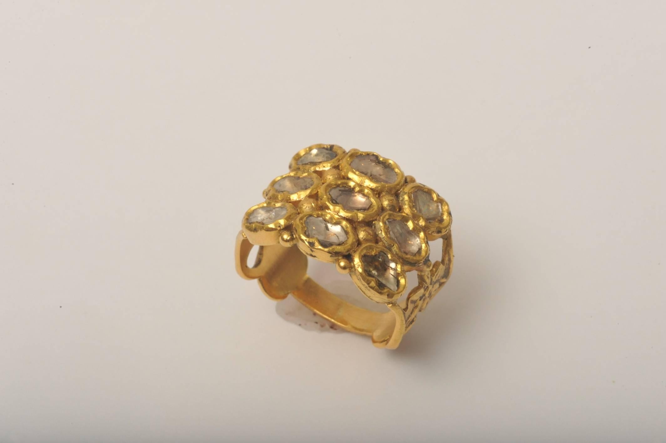 Nine-stone, rose cut diamonds set in 22K gold. Ring size is 6.5.  Dates to the mid-1900's
