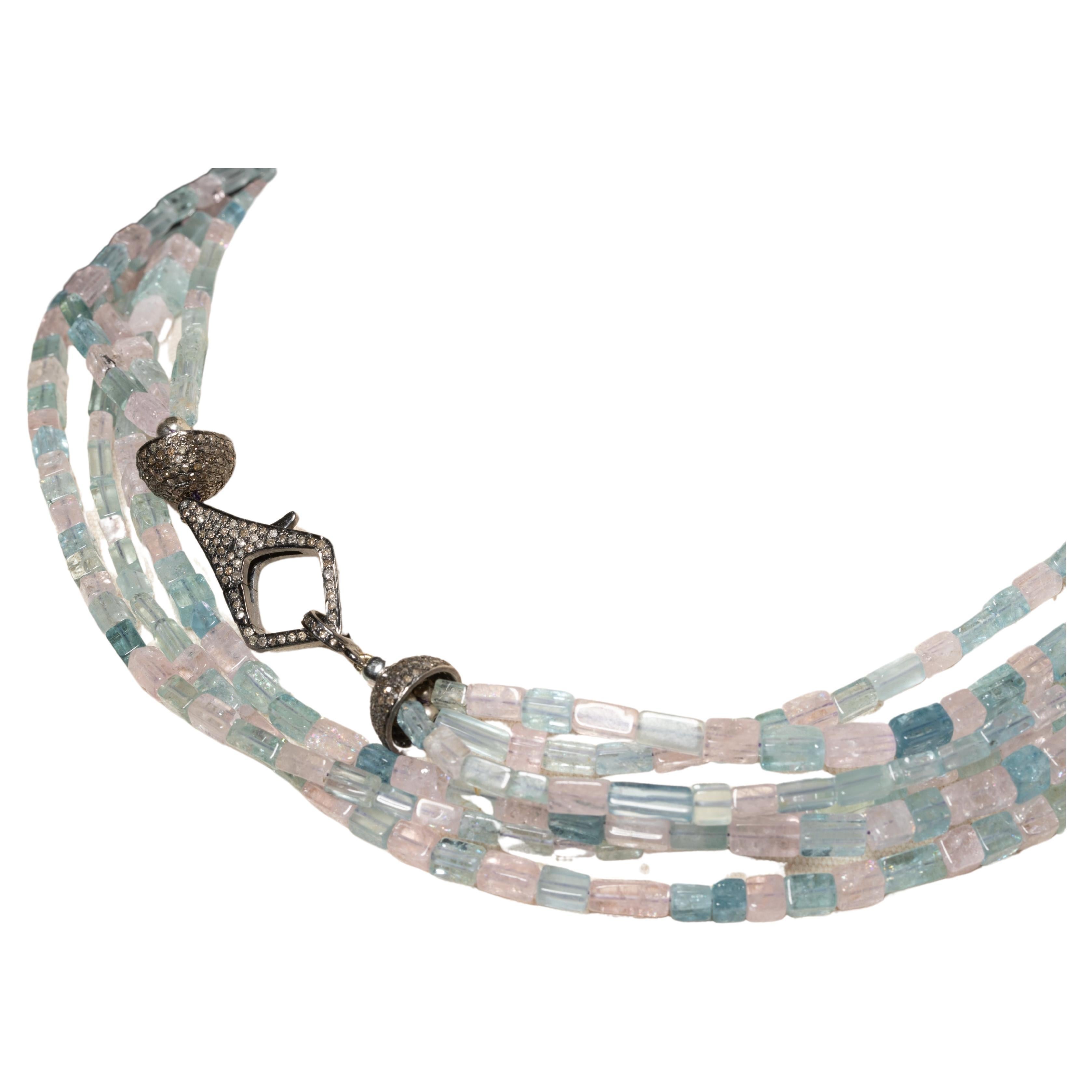A long triple-strand or doubled six-strand necklace of beveled aquamarine and morganite (which is a pink aquamarine as it is in the same beryl family).  With a pave`-set diamond clasp and end-caps set in an oxidized sterling silver, which you can