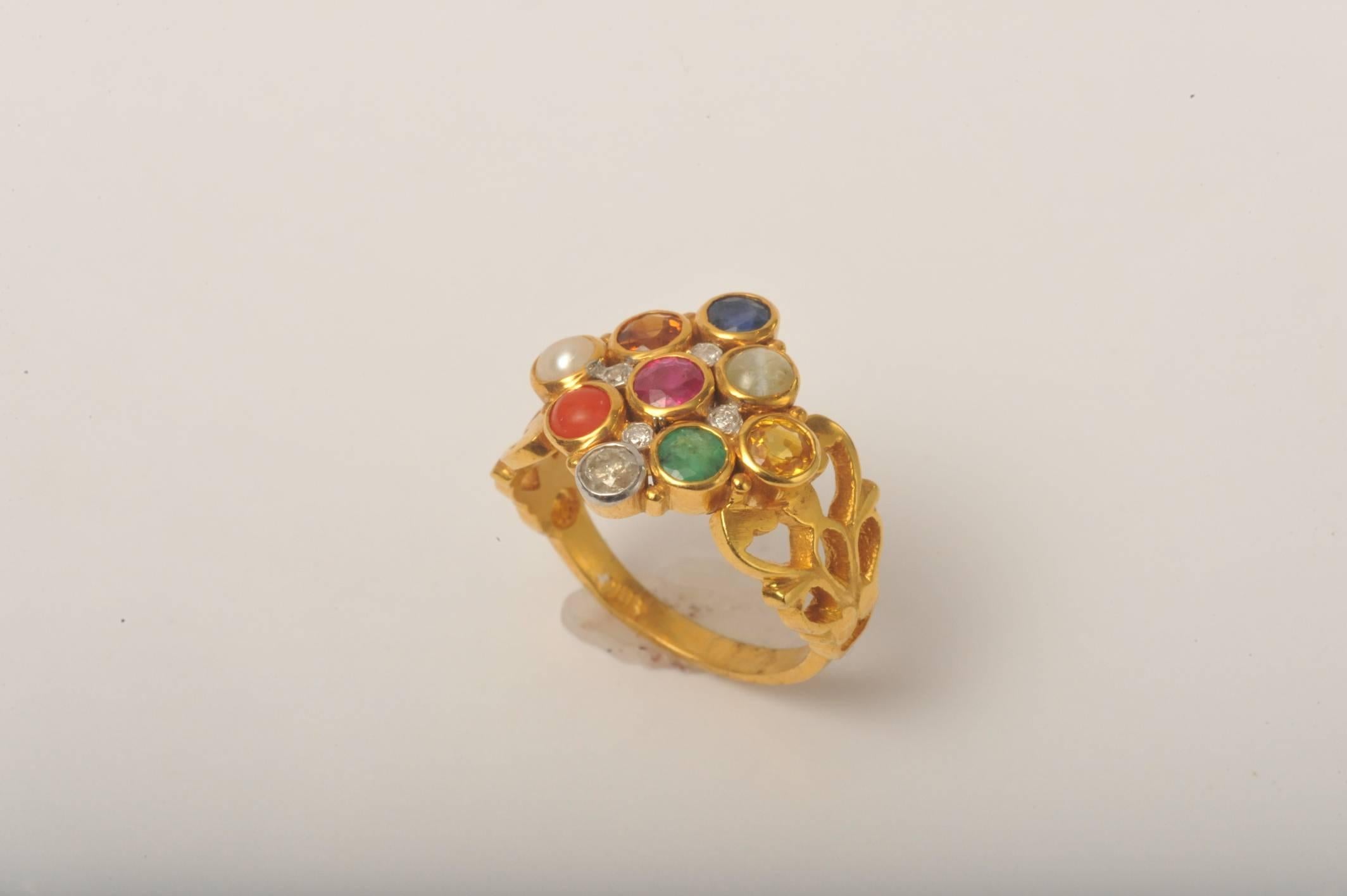 A beautiful combination of stones representing the NavaRatna mythology, bringing good fortune to the wearer.  22K gold with emerald, ruby, sapphire diamonds, pearl, coral, yellow sapphire, hessonite garnet and cats eye.  Each stone is representative