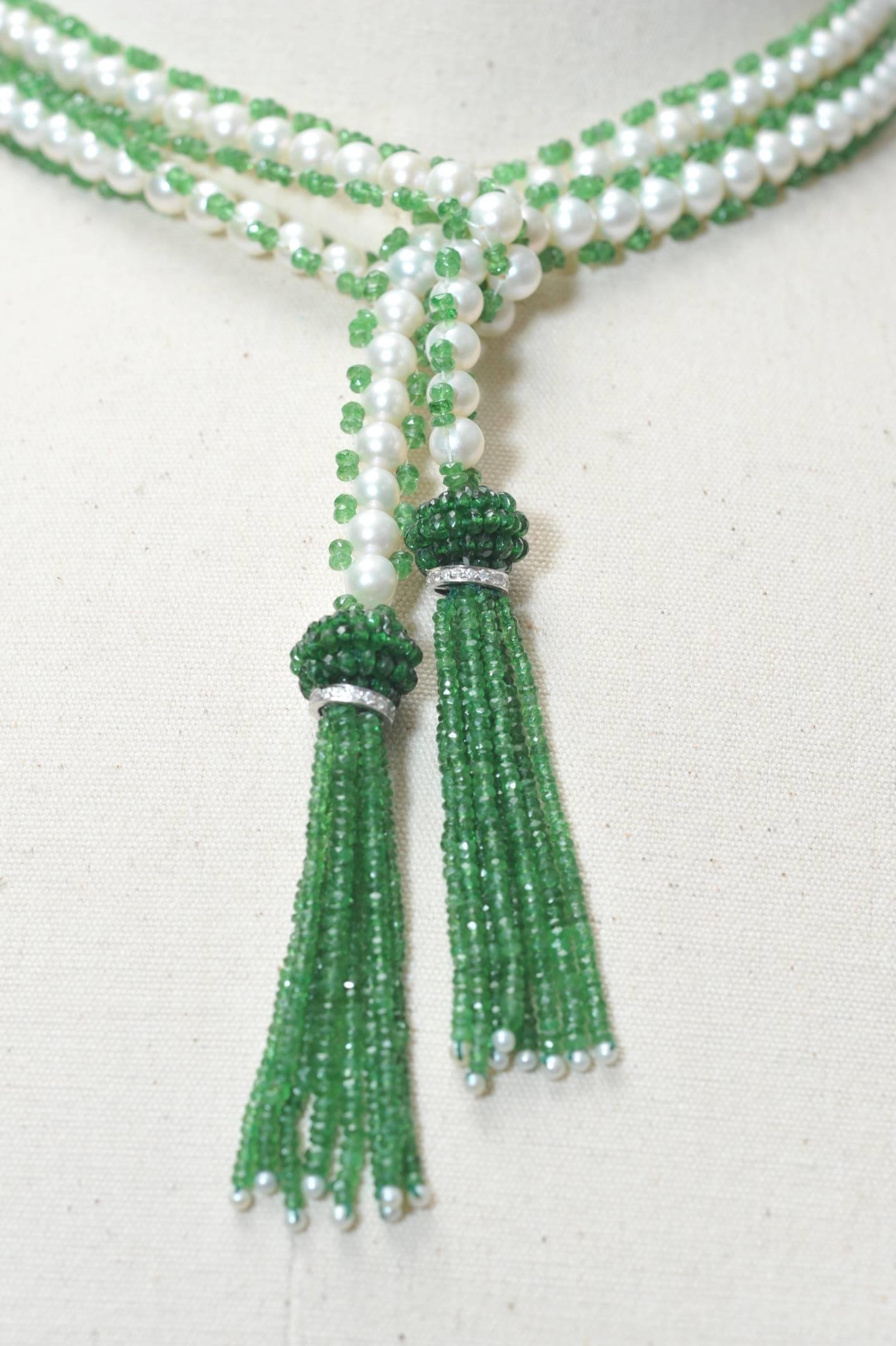 A stunning faceted tsavorite and cultured pearl lariat necklace with 18K white gold and diamond rondelle bordering the beaded tsavorite cluster above the tassel, and seed pearls at the bottom.  Wear this long or short, two very different looks and