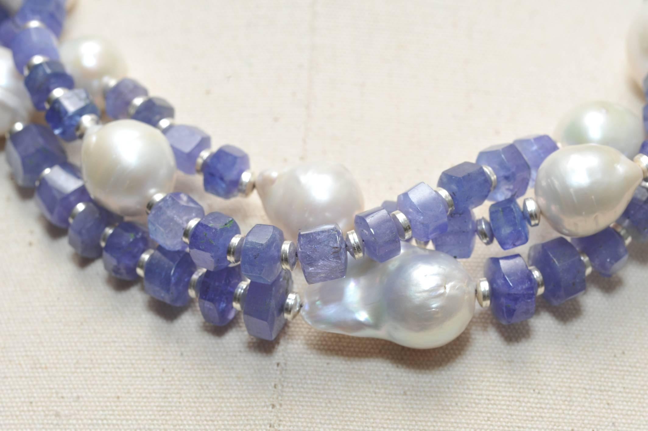 Triple strands of beveled tanzanite, baroque pearls and sterling silver connected to two hand-tooled sterling silver dragons and chain across the back.  Adjusts to 16  inches; or 18 inches long..