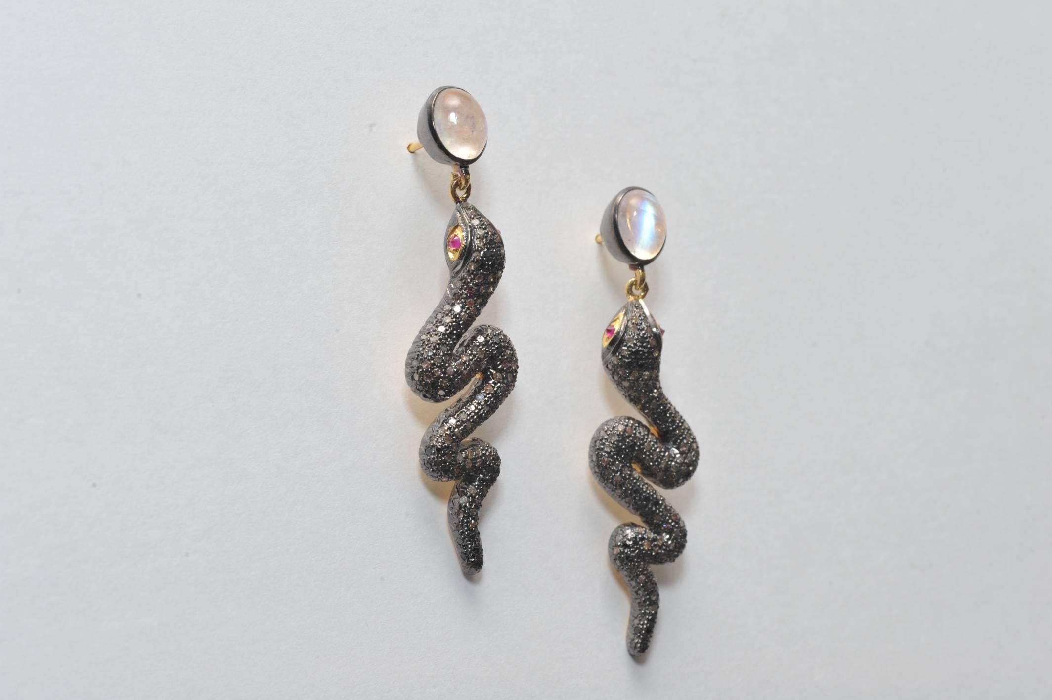 Pave` set diamond snake earrings in oxidized sterling with 18K gold posts with rose quartz cabochon posts and ruby eyes.  Post is 1/4