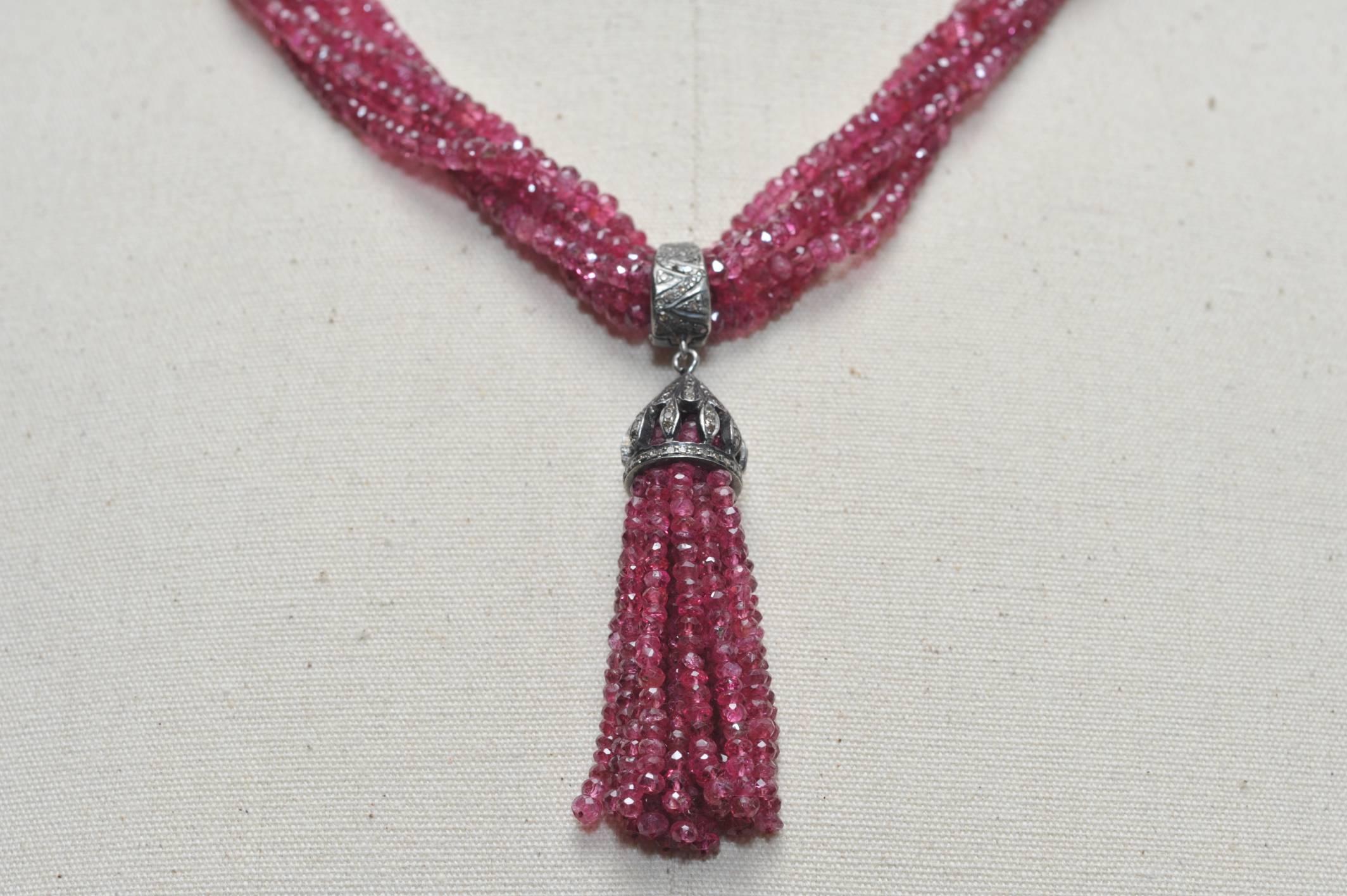 A lovely 5-strand faceted Burmese pink ruby necklace with pave` diamonds on the oxidized sterling bail and tassel cover.  The bail can be removed.  Great life to the rubies which measure 334 carats and 1.16 carats of diamonds.  The tassel itself