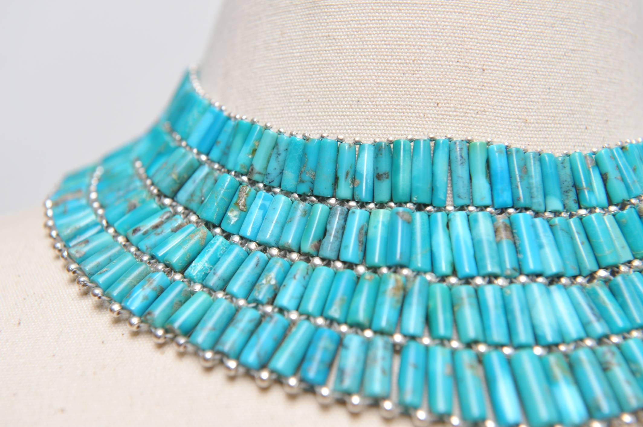 Fantastic and dramatic natural turquoise and sterling silver choker.  It adjusts with a bolero style clasp at the back and a tassel of turquoise at the end which looks great from behind should you choose to feature it.