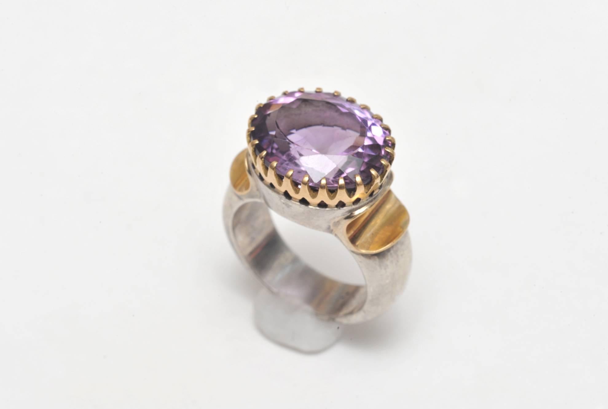 Spectacular 18K gold (weighted, not plated) and sterling silver ring with large, bezel-set faceted amethyst with great color and clarity.   Size is 7.25.  Carat weight of amethyst is 15.

Fine jewelry located on Nantucket Island