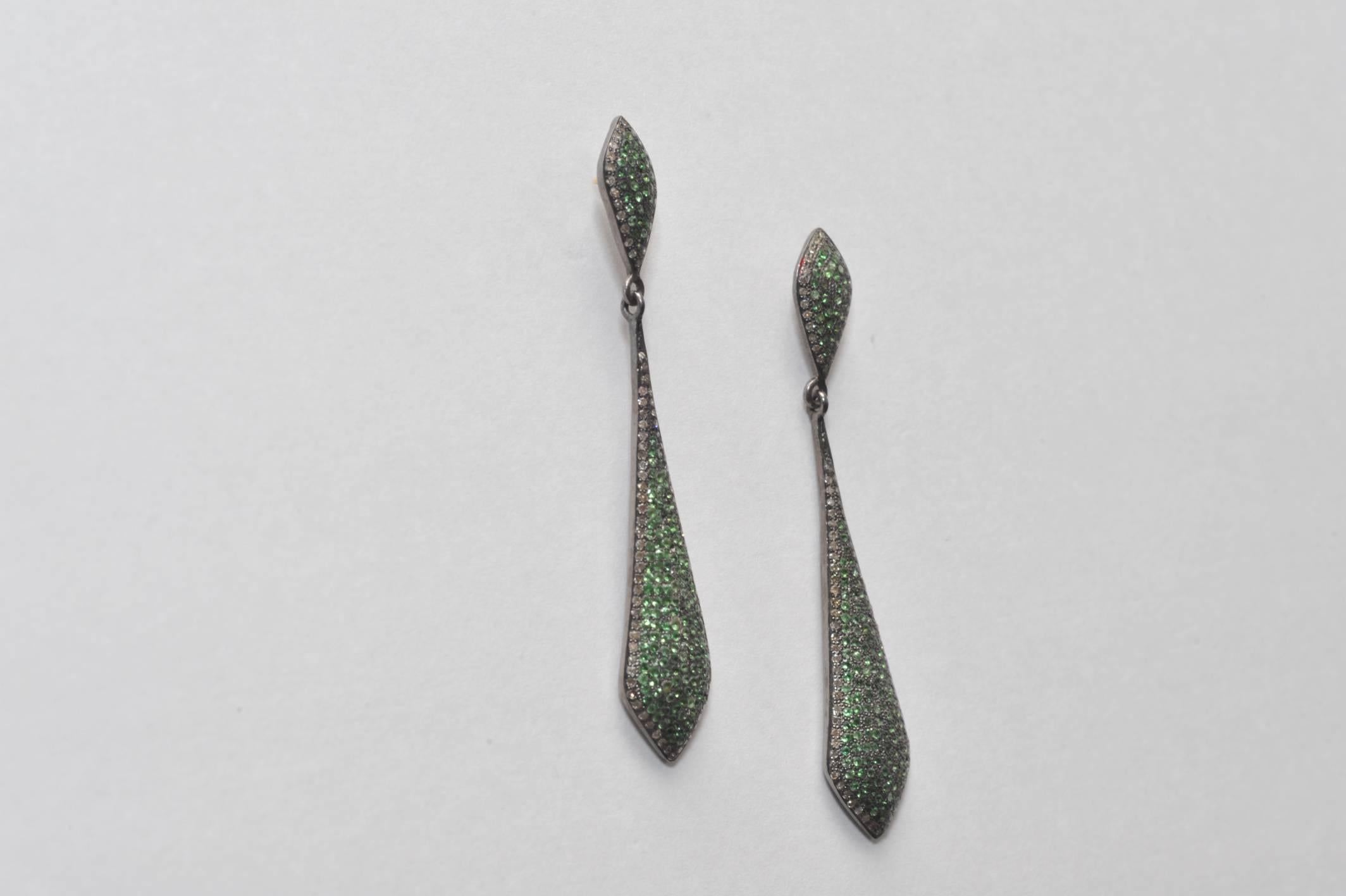 Pair of pave`-set tsavorite stone earrings bordered with diamonds, set in oxidized sterling with 18K gold post for pierced ears.  Carat weight is 1.88; the diamond weight is .72.