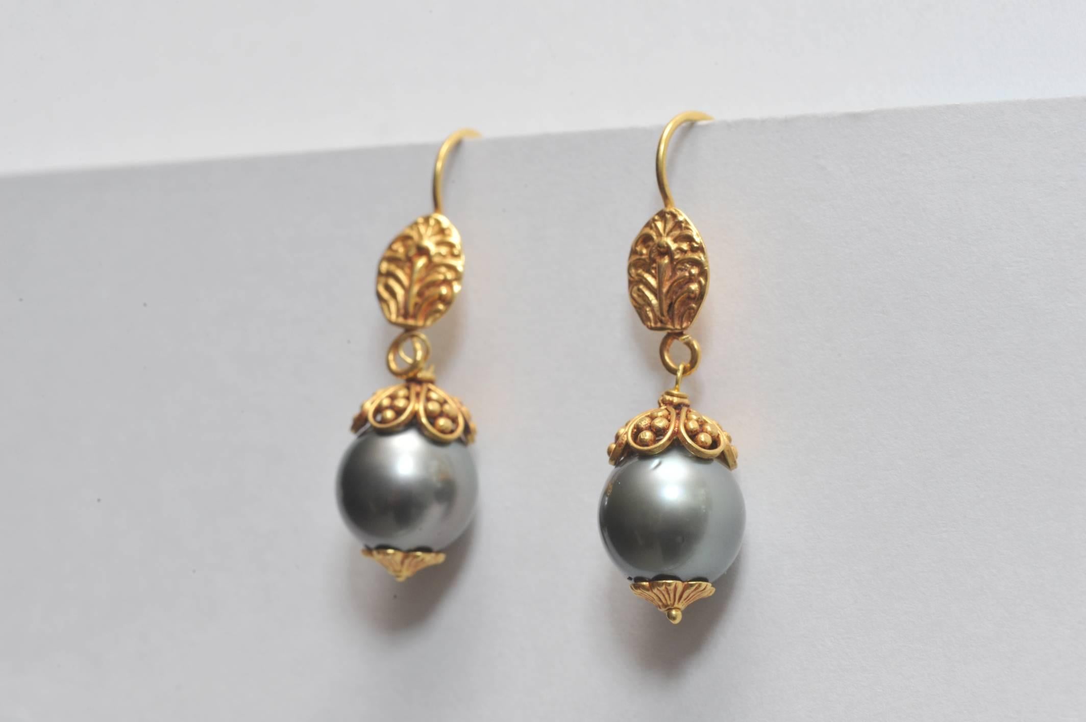 Lovely 9.5 mm Tahitian pearls bordered in 22K gold featuring fine tooling and granulation work.  French wires for pierced ears.