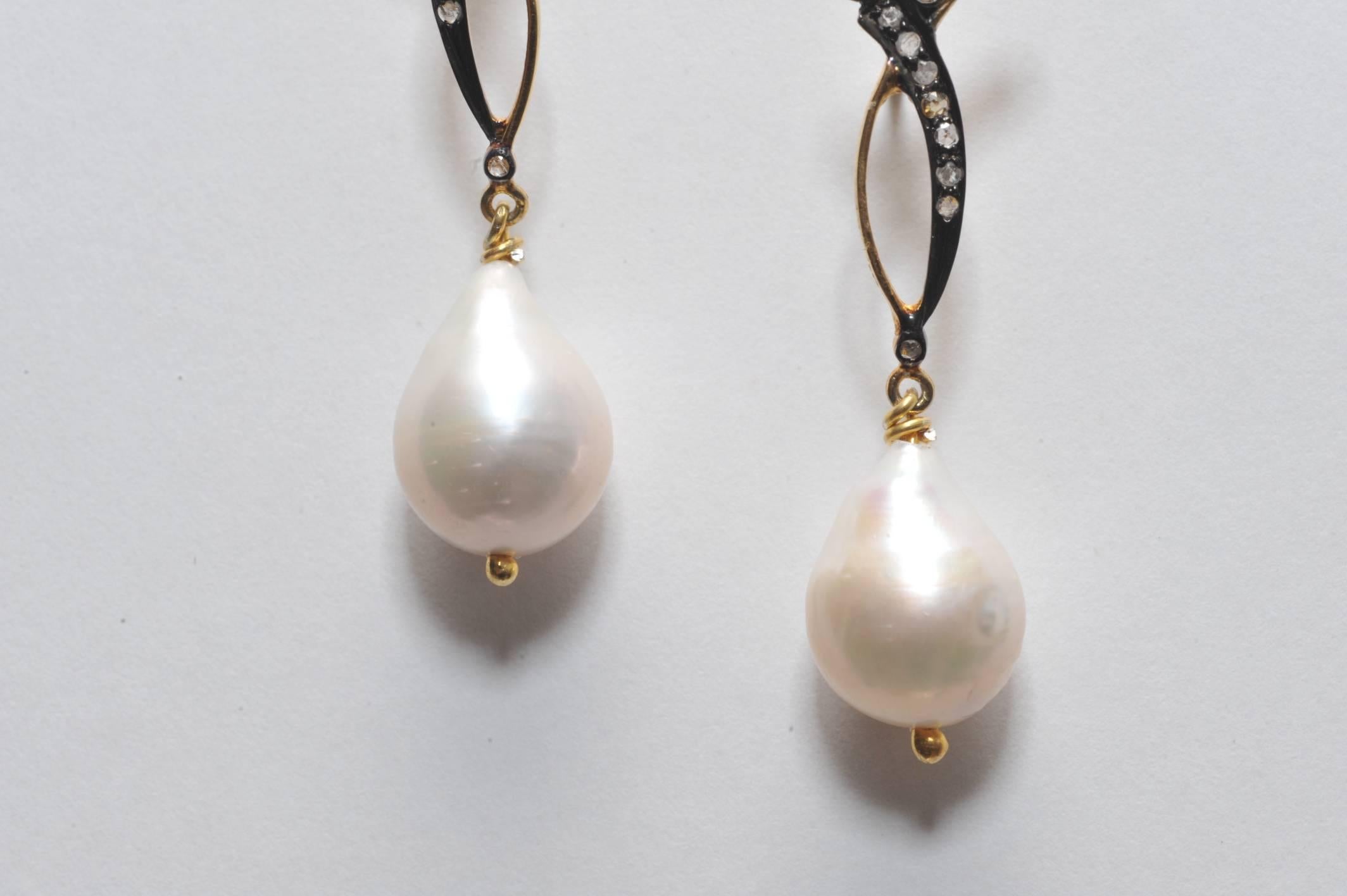 A pair of drop earrings with pear-shaped baroque pearls in a combination of 18K gold and diamonds set in oxidized sterling.  Post is 18K gold for pierced ears.  Pearl weight is 24.05 carats and measure 11mm; diamonds are .27 carats.